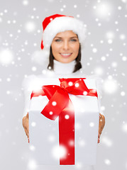 Image showing woman in santa helper hat holding gift box