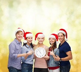 Image showing group of smiling students with clock showing 12