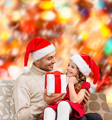 Image showing smiling father giving daughter gift box