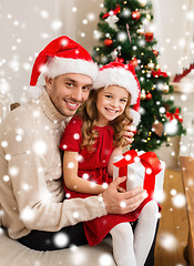 Image showing smiling father and daughter holding gift box