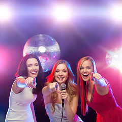 Image showing three smiling women dancing and singing karaoke