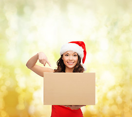 Image showing smiling woman in santa helper hat with parcel box