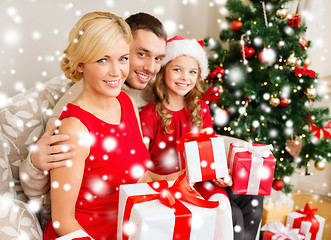 Image showing smiling family holding many gift boxes