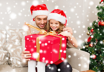 Image showing smiling father and daughter opening gift box