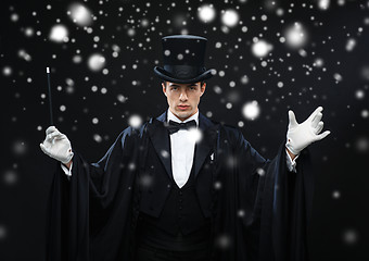 Image showing magician in top hat with magic wand showing trick