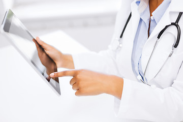 Image showing female doctor working with tablet pc