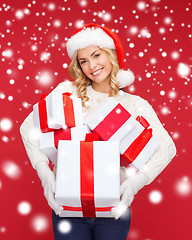 Image showing woman in santa helper hat with many gift boxes