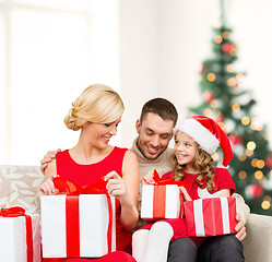 Image showing happy family opening gift boxes