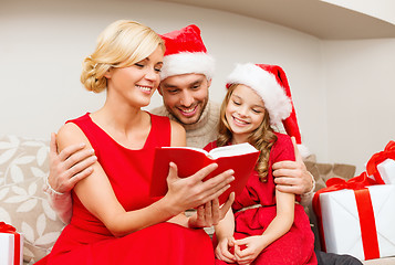 Image showing smiling family reading book