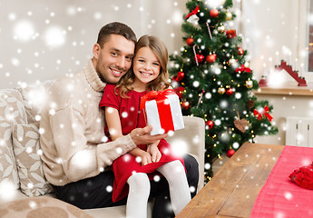 Image showing smiling father and daughter holding gift box