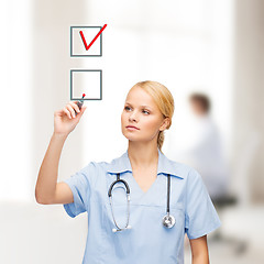 Image showing doctor or nurse with marker drawning red checkmark