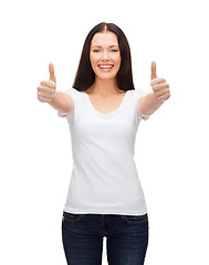 Image showing smiling woman in white t-shirt showing thumbs up