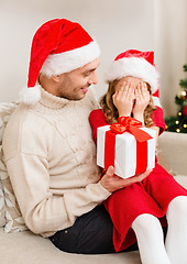 Image showing smiling daughter waiting for a present from father