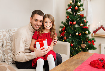 Image showing smiling father and daughter holding gift box