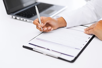 Image showing female doctor writing prescription