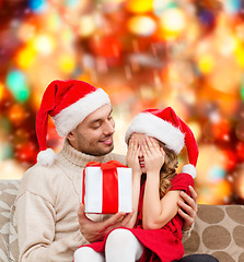 Image showing smiling daughter waiting for a present from father