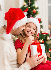 Image showing smiling father and daughter opening gift box