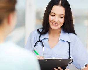 Image showing smiling doctor or nurse with patient