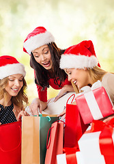 Image showing women in santa helper hats with shopping bags