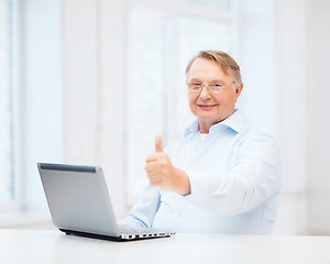 Image showing old man with laptop computer showing thumbs up