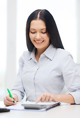Image showing businesswoman or student working with calculator
