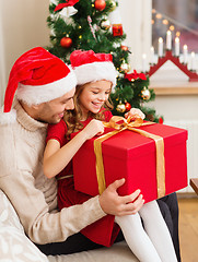 Image showing smiling father and daughter opening gift box