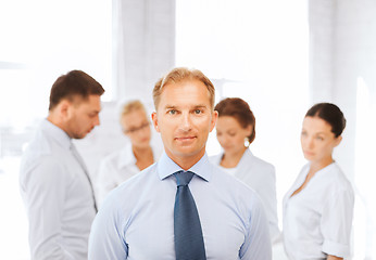 Image showing businessman in office with group on the back