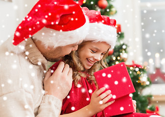 Image showing smiling father and daughter opening gift box