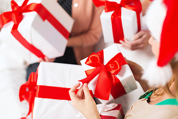 Image showing three women holding many gift boxes