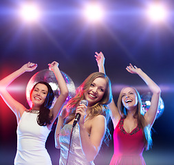 Image showing three smiling women dancing and singing karaoke