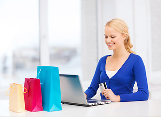 Image showing woman with laptop, shopping bags and credit card