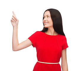 Image showing young woman in red dress pointing her finger