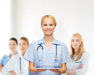 Image showing smiling female doctor or nurse with tablet pc