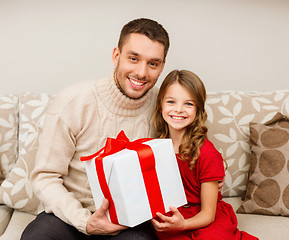 Image showing smiling father and daughter holding gift box