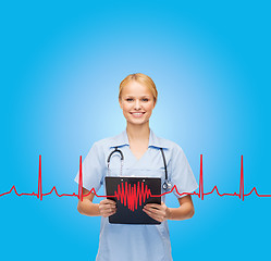 Image showing smiling female doctor or nurse with clipboard