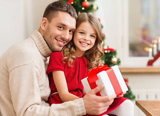 Image showing smiling father and daughter holding gift box