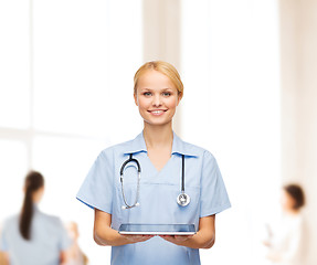 Image showing smiling female doctor or nurse with tablet pc