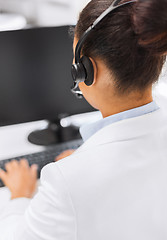 Image showing friendly female helpline operator with headphones