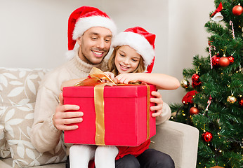 Image showing smiling father and daughter opening gift box