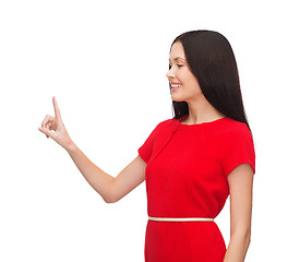 Image showing young woman in red dress pointing her finger