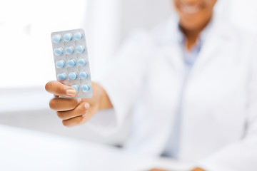 Image showing female doctor hand giving pack of pills