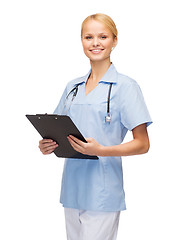 Image showing smiling female doctor or nurse with clipboard