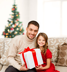 Image showing smiling father and daughter holding gift box