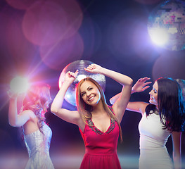 Image showing three smiling women dancing in the club