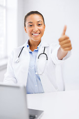 Image showing female doctor with laptop showing thumbs up