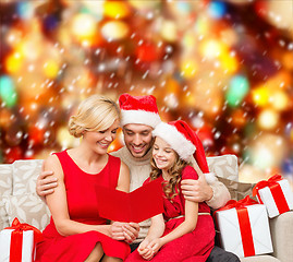 Image showing smiling family reading postcard