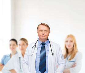 Image showing smiling doctor or professor with stethoscope