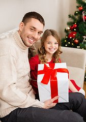 Image showing smiling father and daughter holding gift box