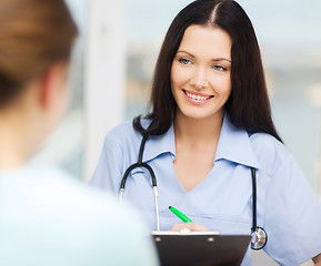 Image showing smiling doctor or nurse with patient