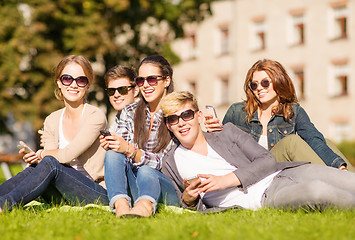 Image showing students looking at smartphones and tablet pc